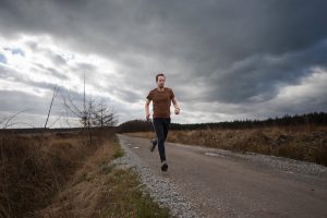 Man Jogging Down The Road